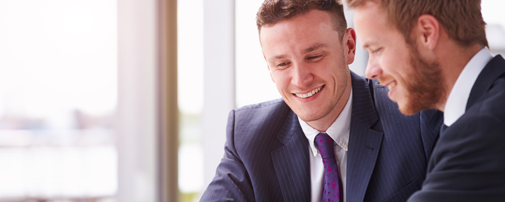 Two Men in Office Smiling