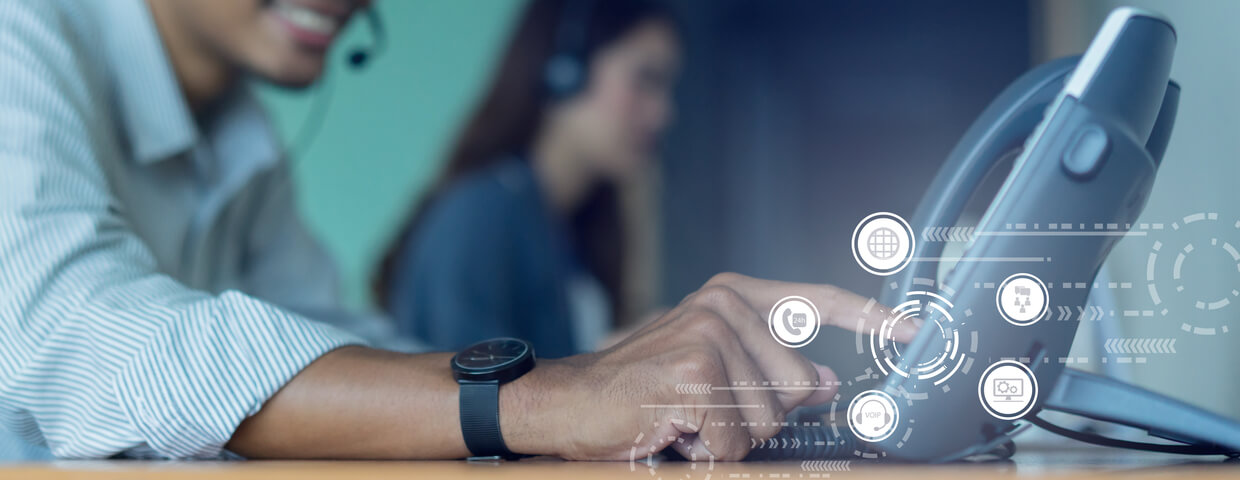 close up employee call center man hand point to press button number on telephone office desk with virtual communication technology concept