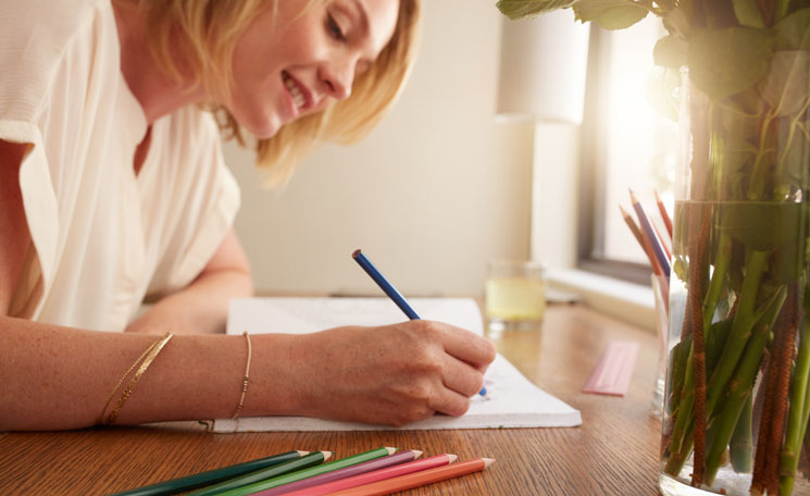 Woman coloring in coloring book