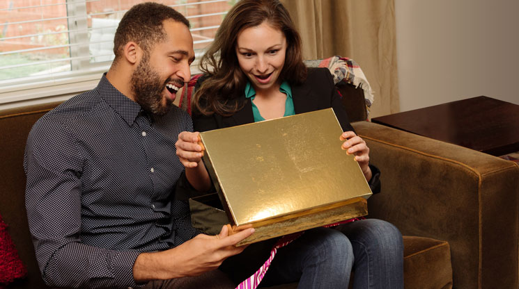 Couple opening a gift